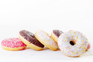 multi-colored donuts on a white background