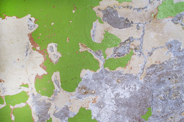 Old green peeling wall of abandoned spaces beautifully covered with colored spots, copy space.