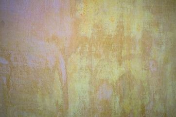 Detail of old yellow walls of the room, preparing to repair, beautifully covered with colored spots, copy space.