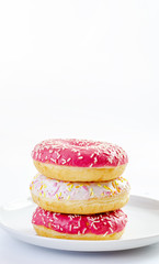multi-colored donuts on a white background