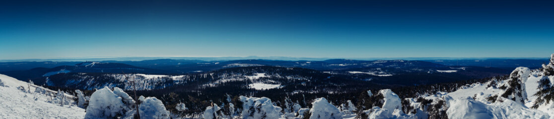 Fototapeta na wymiar Winter mountain landscape panorama from the mountain top to the valley in winter with snow. Brocken Plateau, National Park Harz Mountains in Germany