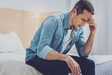Negative delighted man being deep in thoughts