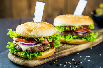 Delicious hamburgers on wooden background 