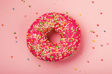 Strawberry donut on a pink background, top view