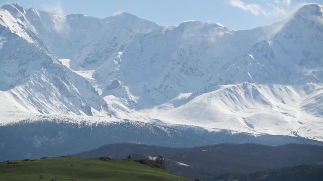Landscape view: snow-capped altai mountain peaks with forest hills on foothills. Extreme travel to wild nature. National wildlife refuge. Amazing mongolian highland.