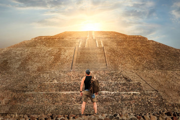 Sporty young tourist on the background of a Teotihuacan sunset. Pyramid of the Sun. Travel and freedom concept.