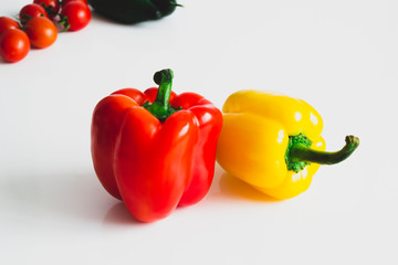 Bulgarian pepper with tomatoes and cucumbers on a white background
