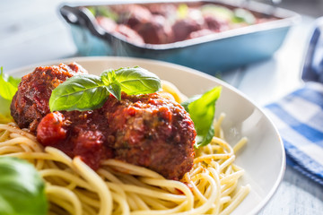 Delisious italian meal meat beef balls with pasta spaghetti and basil in white plate.