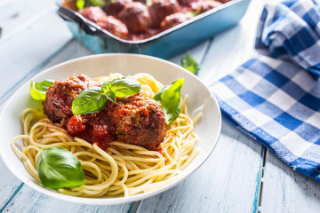 Delisious italian meal meat beef balls with pasta spaghetti and basil in white plate.