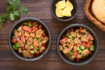 Salad made of Chilean cochayuyo (lat. Durvillaea antarctica) or bull kelp edible seaweed, cherry tomato, bell pepper, onion and parsley, photographed overhead with natural light