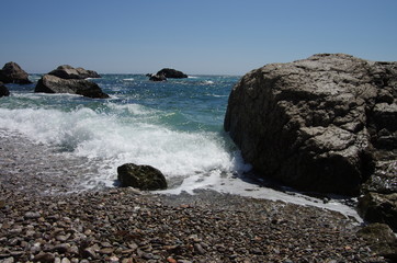 Storm of the sea on the stone beach.