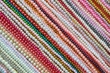 Diagonal lines patterns of multicolored bead necklaces accessories in horizontal frame on ornaments background decoration design concept