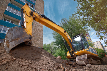 Repair of city communications. Pipeline installation. Excavator at construction site in the city...