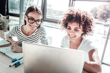 Positive delighted friends having video conference