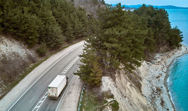air view of the road by the sea with trucks