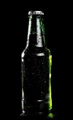 Beer bottle with drops isolated on black, with clipping path 