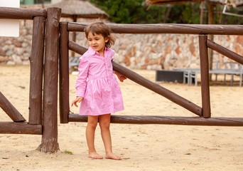 Obraz premium Happy little girl relaxing by the beach