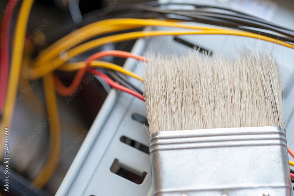 Poster desktop computer dust cleaning with tassel. computer power wires.