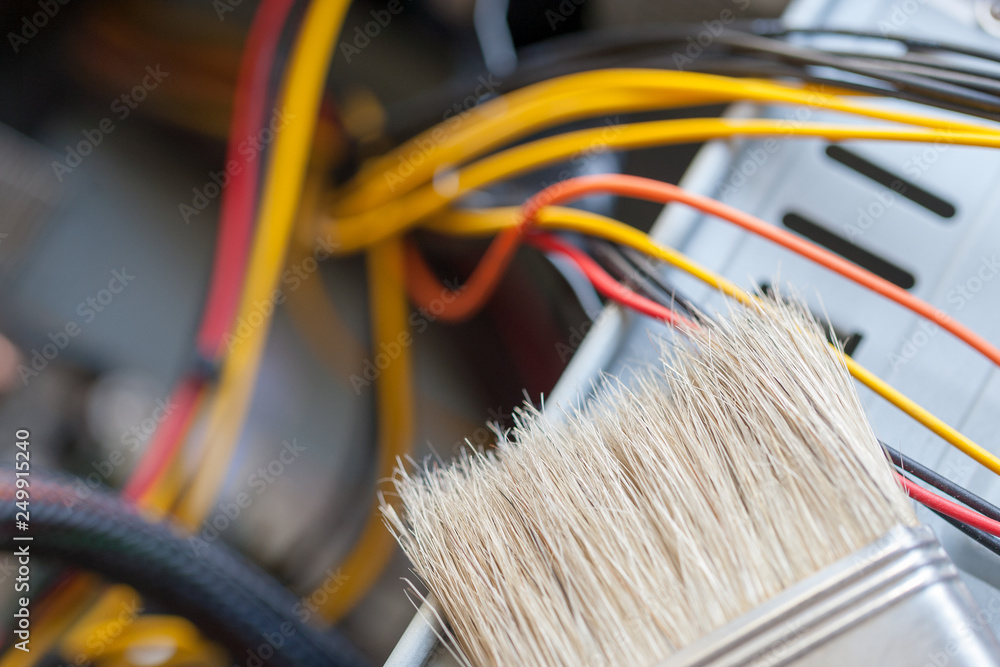 Poster desktop computer dust cleaning with tassel. computer power wires.