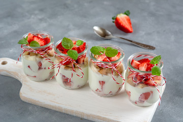Yoghurt with fresh strawberries and crumbled biscuits. Healthy breakfast.