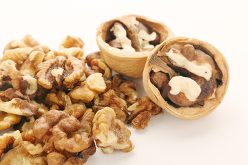 A pile of peeled walnuts at white background	