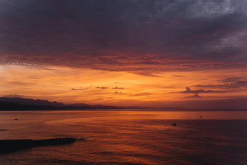 Fototapeta na wymiar nature landscape red sunrise over sea ocean