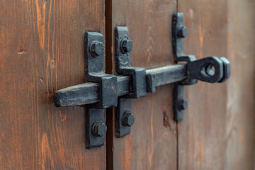 Padlock on the garage door. Gate locked on the castle. Vintage, old.Door hinges. closed.
