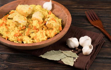 .pilaf with meat in a wooden plate