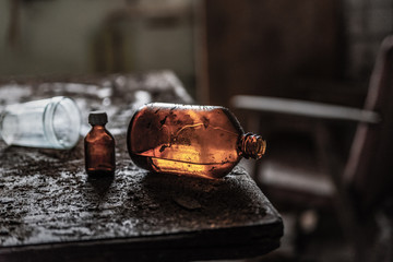 an old bottle of glycerin is on the old table