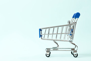 Discounts concept. Shopping cart  on a blue background with space for text
