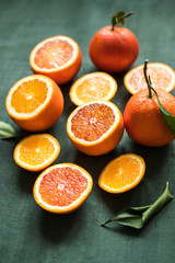 Juicy citrus fruits. Ripe oranges on green background close up.