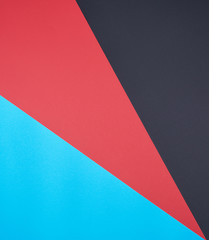 abstract background of multicolored paper, black, red and cyan colors