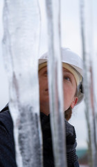 engineer is surprised at the formation of large icicles. Close-up.