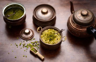 Traditional Turkish dessert; halva with pistachio in copper cup