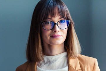 Fototapeta premium Portrait of beautiful young woman in eyeglasses