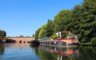 Barge near old bridge "Barrage Vauban" in Strasbourg - France