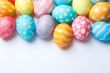 Fototapeta na wymiar Decorative Easter eggs on white background, space for text. Top view