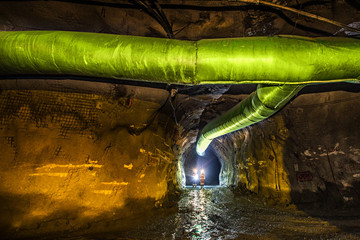 Miners inspecting an underground ventilation system in a gold mine in Australia