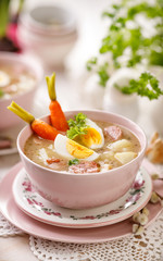 Bowl of the the sour soup (Żurek), polish Easter soup with the addition of sausage, hard boiled egg and vegetables . Traditional Easter dish in Poland