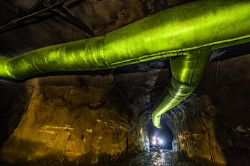 Miners inspecting an underground ventilation system in a gold mine in Australia