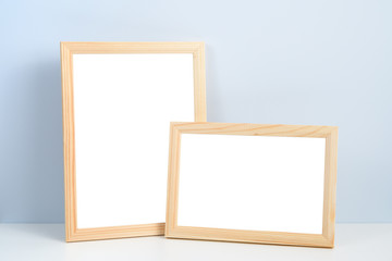 Wooden photo frames standing on shelf - 249925202