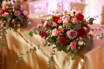 A table of newlyweds for wedding holidays with a magnificent bouquet of fresh flowers.