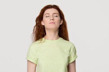 Calm mindful redhead woman taking deep breath feel free