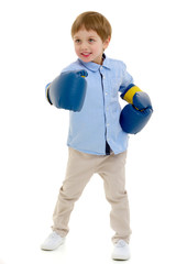 A little boy in a clean white T-shirt is engaged in fitness.