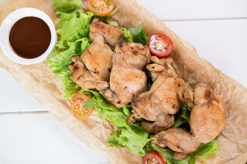 Grilled chicken  with salad,tomatoes and sauce on wooden table