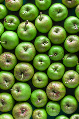 Fresh green organic apples overhead large colorful arrangement  in studio