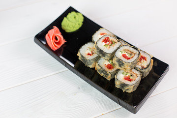 Sushi and rolls on black plate. Sea healthy japanese asian food