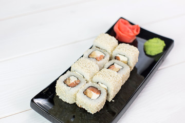 Sushi and rolls on black plate. Sea healthy japanese asian food