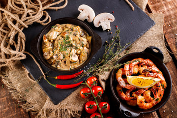 Fried large shrimp in tomato sauce with olive oil,Mushrooms in cream sauce, julienne, champignon, products for cooking