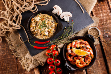 Fried large shrimp in tomato sauce with olive oil,Mushrooms in cream sauce, julienne, champignon, products for cooking